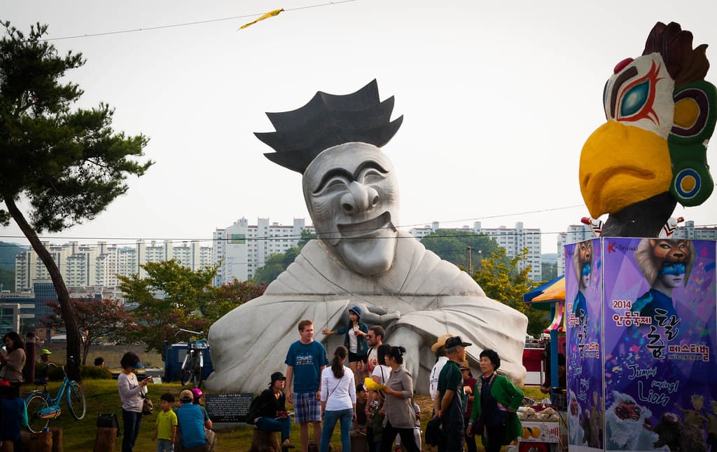 A giant white hahoe mask sculpture towering over visitors at the Andong Mask Dance Festival
