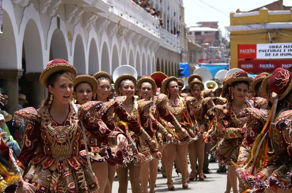 A line of dancers in embroidered costumes at the Carnaval de Oruro