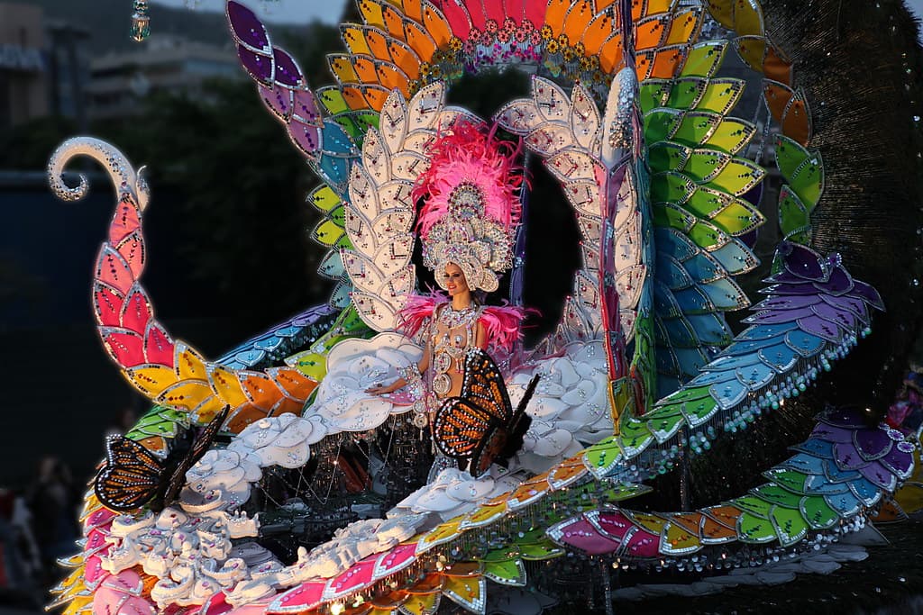 A carnival queen candidate in an enormous multicoloured costume of feathers and sequins in Santa Cruz de Tenerife