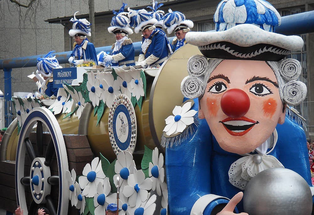 A carnival float with a giant jester figure during the Cologne Carnival parade