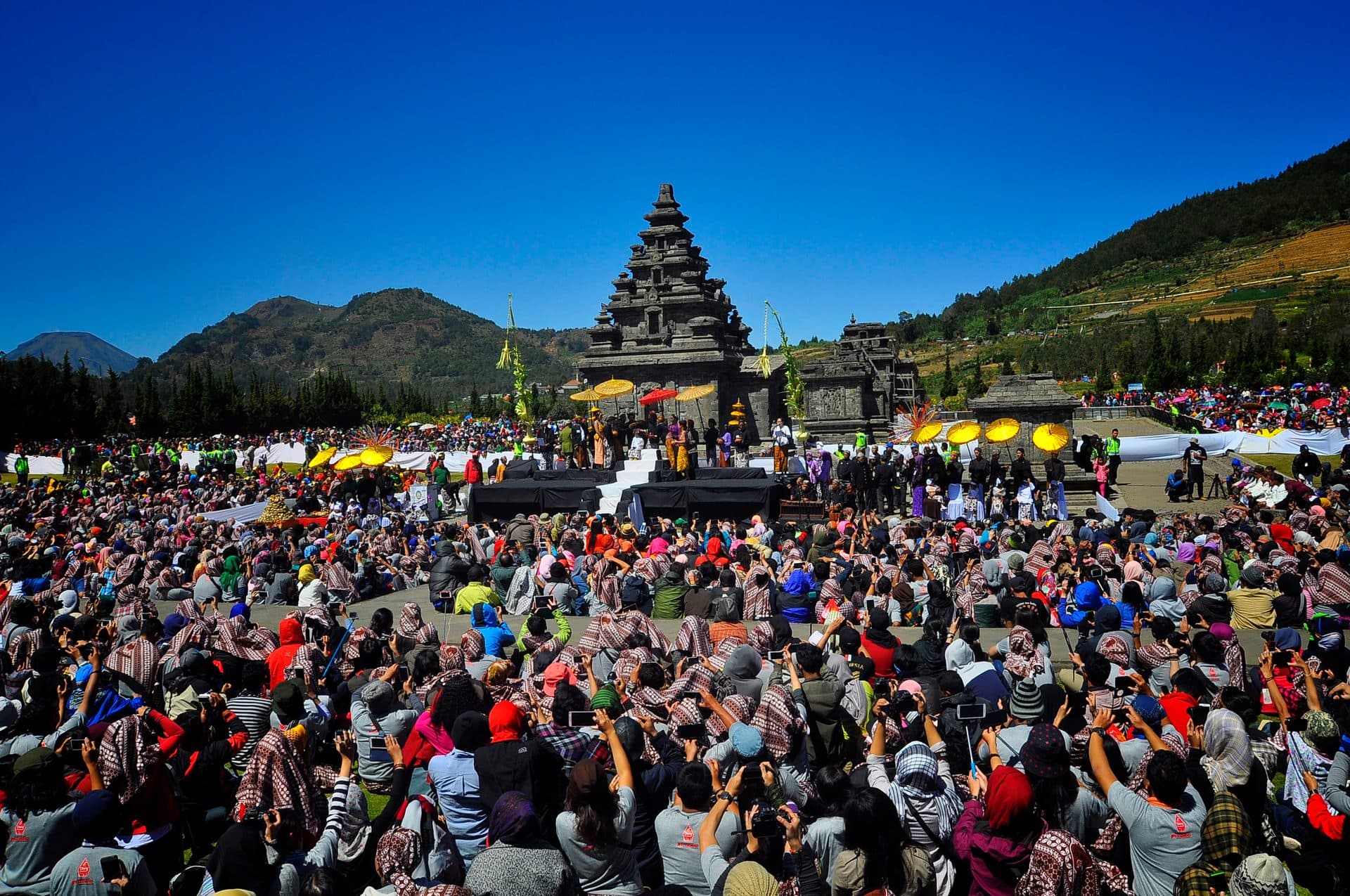 Crowds gather before an ancient Hindu temple on the Dieng Plateau for the dreadlock-cutting ceremony of the Dieng Culture Festival