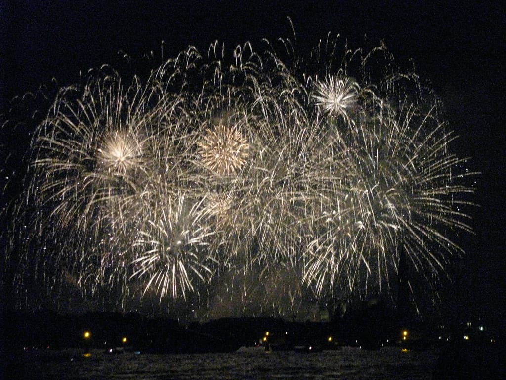 Golden fireworks burst over the dark water of St Mark's basin in Venice on the night of the Redentore