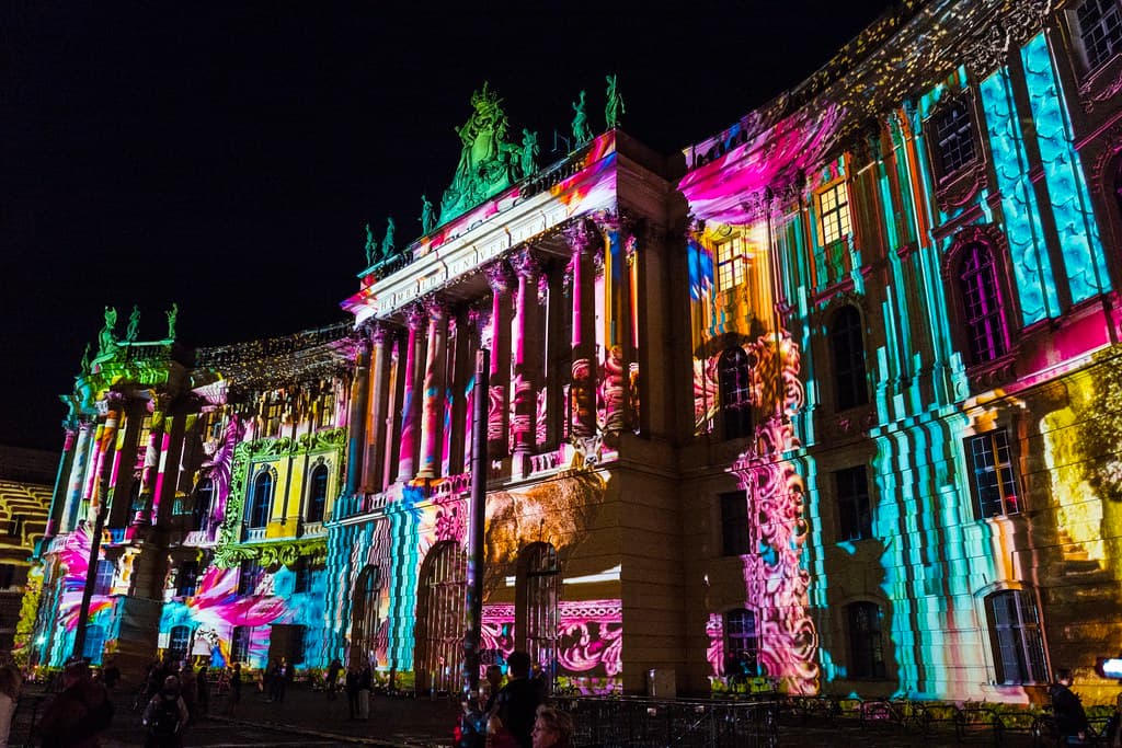 Colorful light projections covering a historic facade during the Festival of Lights in Berlin