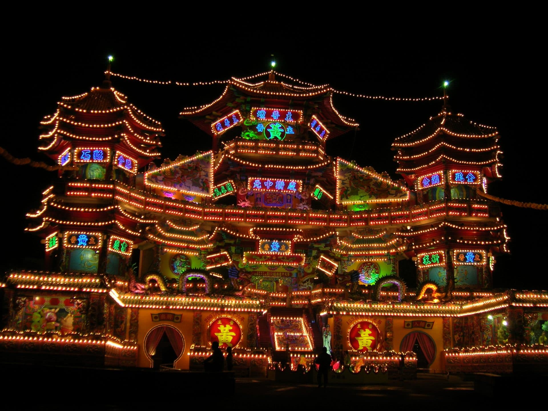 A temple-shaped structure outlined in thousands of lights glows at night during Keelung's Ghost Festival in Taiwan