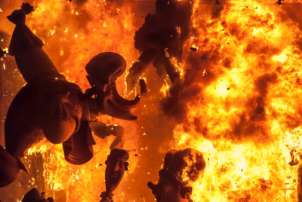 A falla sculpture engulfed in flames during the Cremà, the burning night of Las Fallas in Valencia