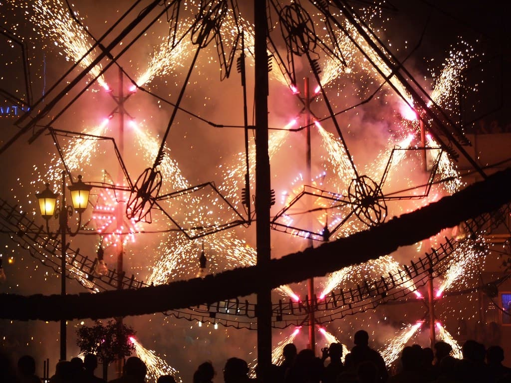 A huge spinning Catherine wheel of fireworks lights up the night during a village festa in Żurrieq, Malta