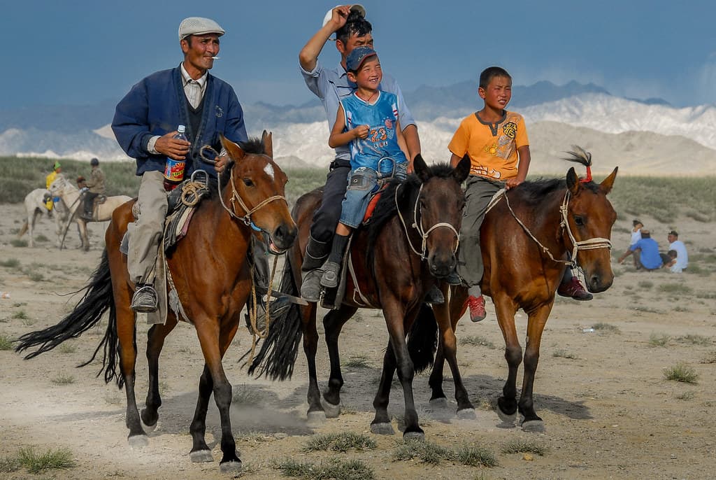 Young riders on horseback on the Mongolian steppe at Naadam