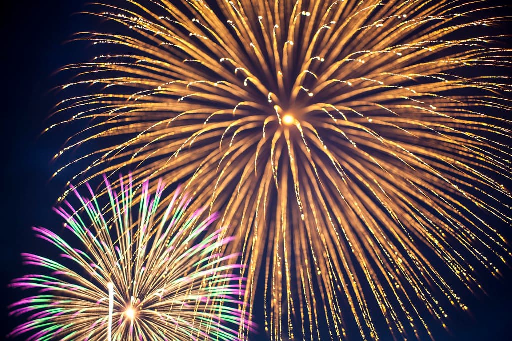 Huge golden and multicoloured firework bursts fill the night sky at the Nagaoka fireworks festival