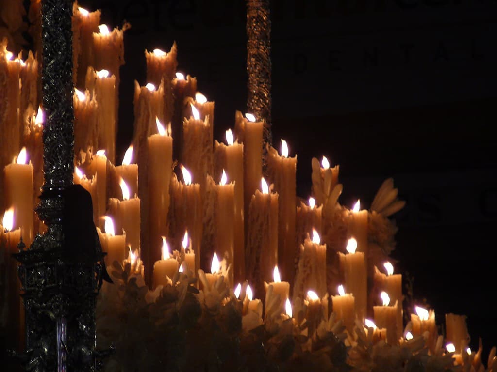 Rows of candles lit on a procession float in Seville during Semana Santa