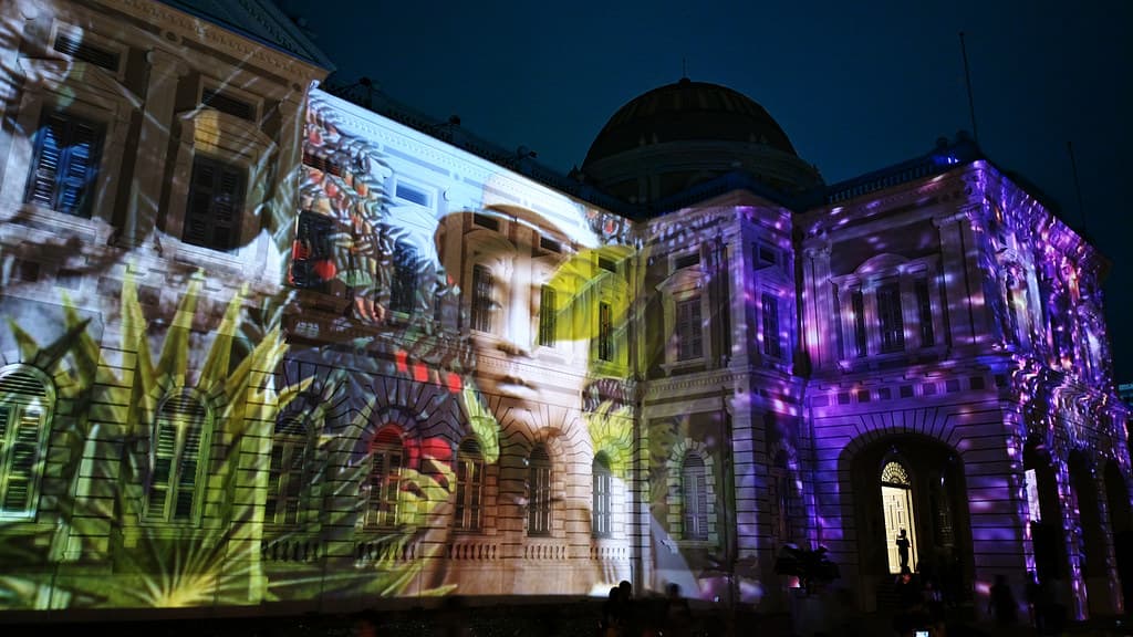 A light projection covering a historic building facade at the Singapore Night Festival