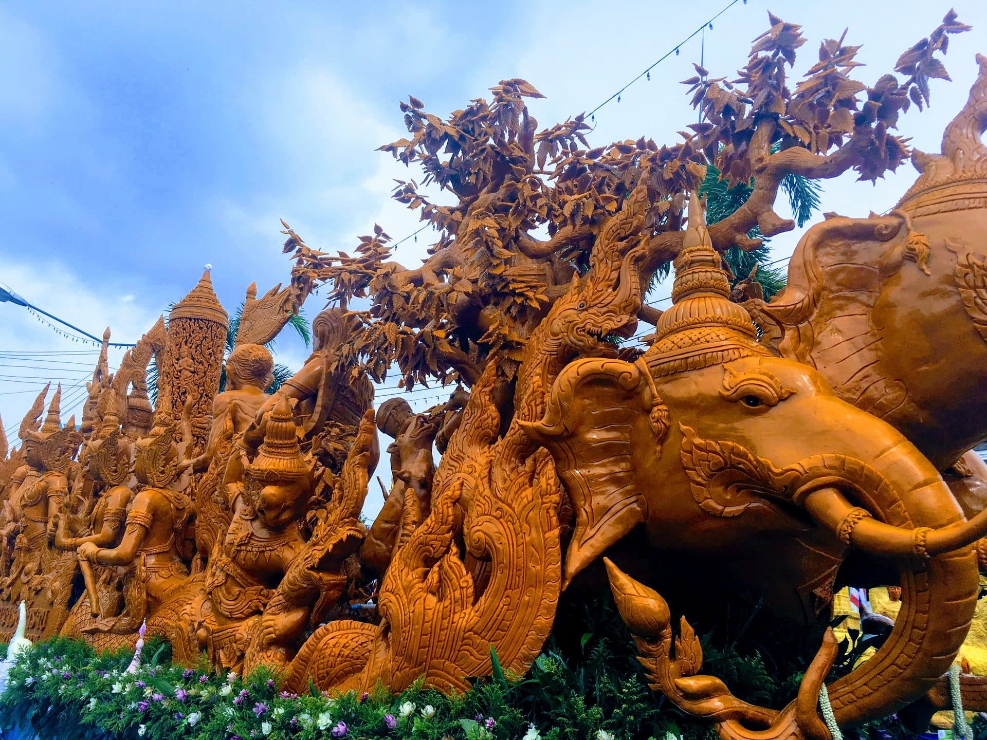 A towering carved wax float with an elephant and mythical figures at the Ubon Ratchathani Candle Festival