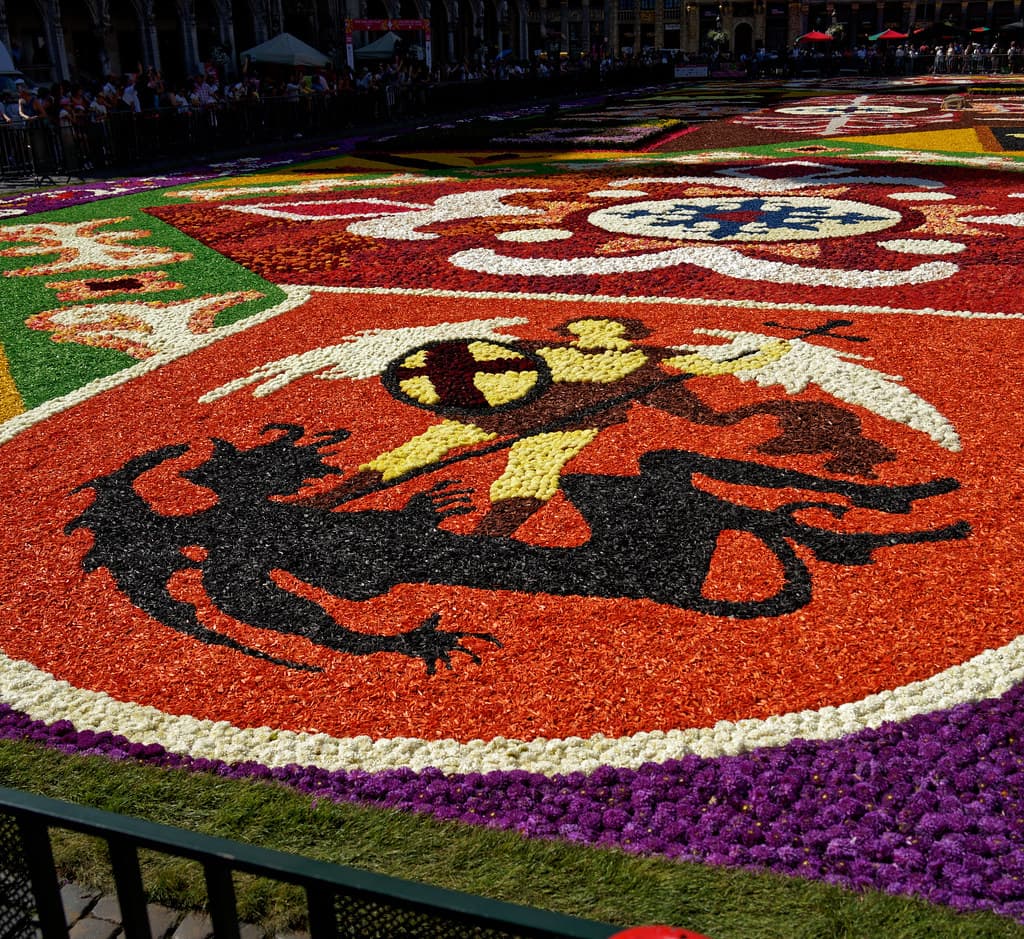 Visitors look out over the flower carpet laid across the Grand-Place in Brussels in 2022