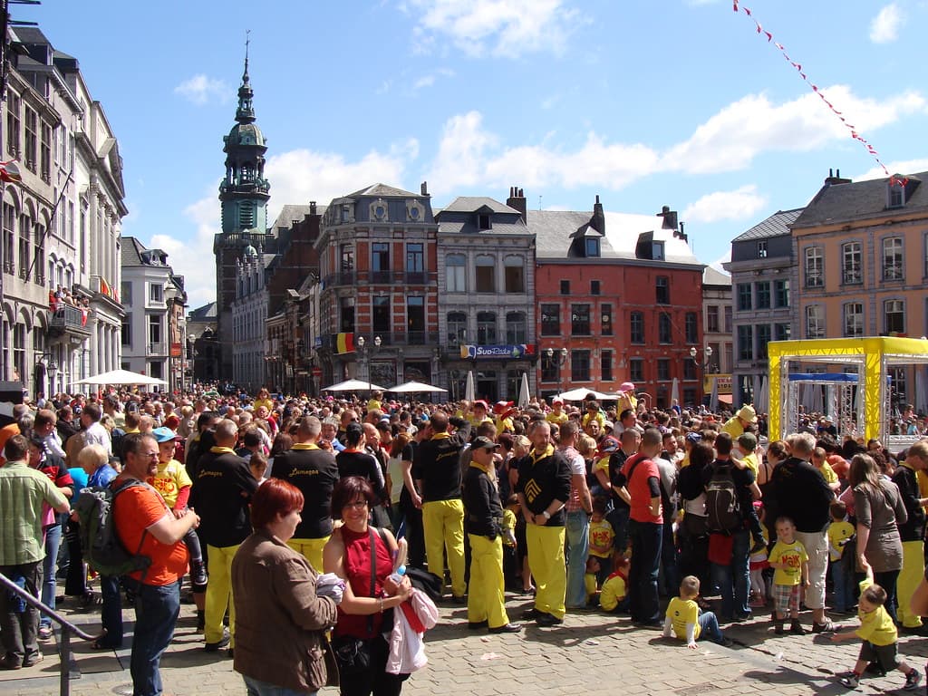 Crowds fill the Grand-Place of Mons below the belfry and gabled houses on the weekend of the Doudou