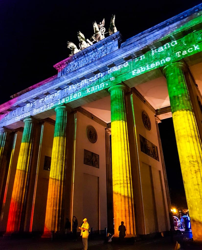 The Brandenburg Gate lit in bands of color during the Festival of Lights
