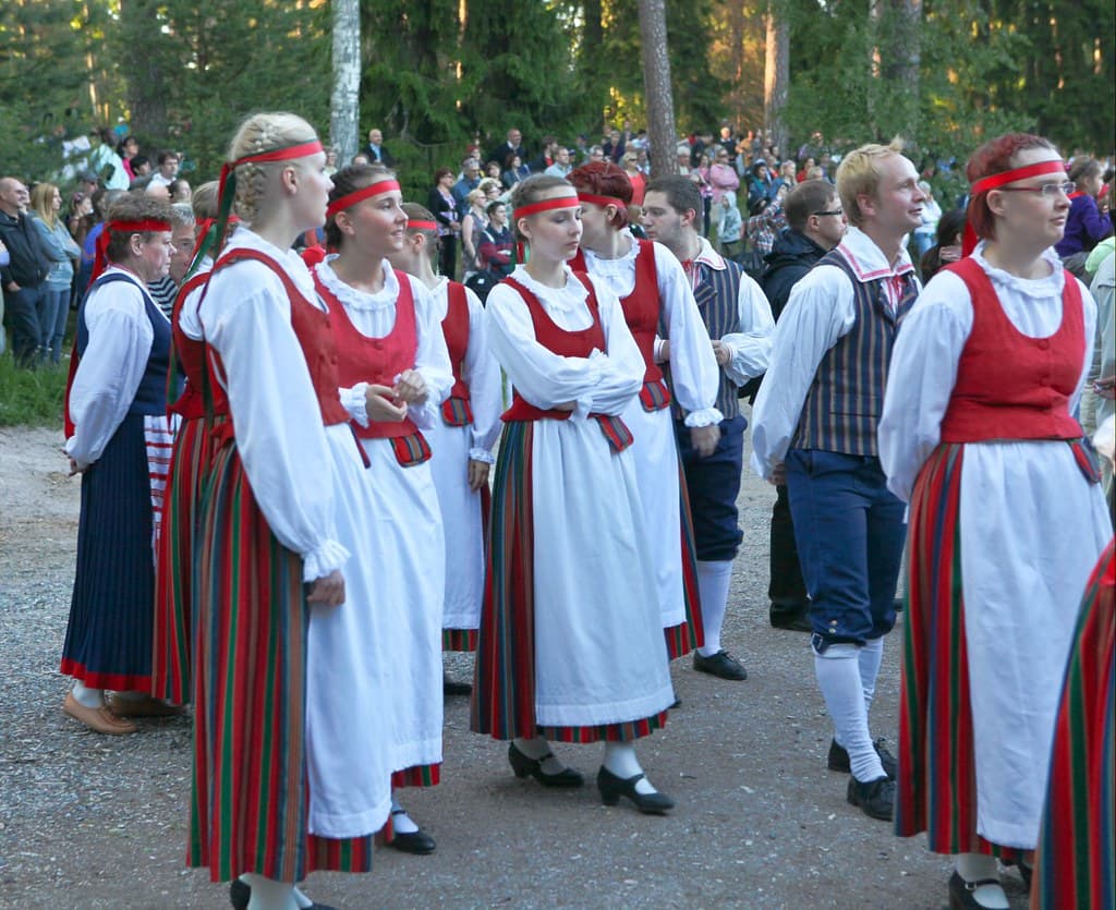 Folk dancers in traditional Finnish costume gather at the Seurasaari open-air museum in Helsinki on Midsummer Eve