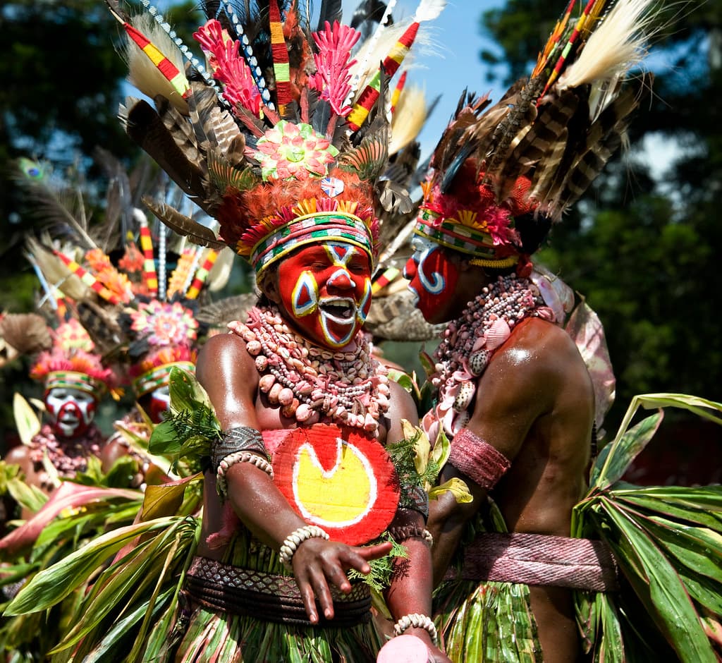 Highland performers in tall feathered headdresses, painted faces and leaf skirts at the Mount Hagen Show
