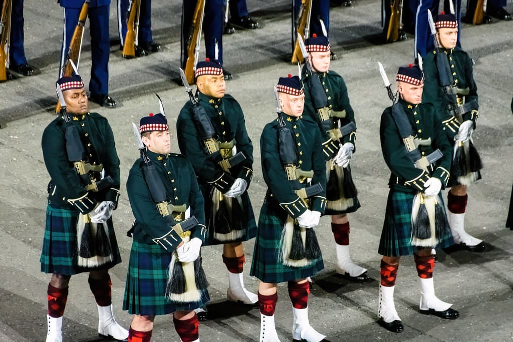 Pipers in kilts and feather bonnets march in formation on the esplanade during the Royal Edinburgh Military Tattoo