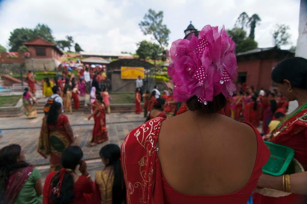 Women in red clothing gather in the temple grounds of Pashupatinath in Kathmandu on Teej